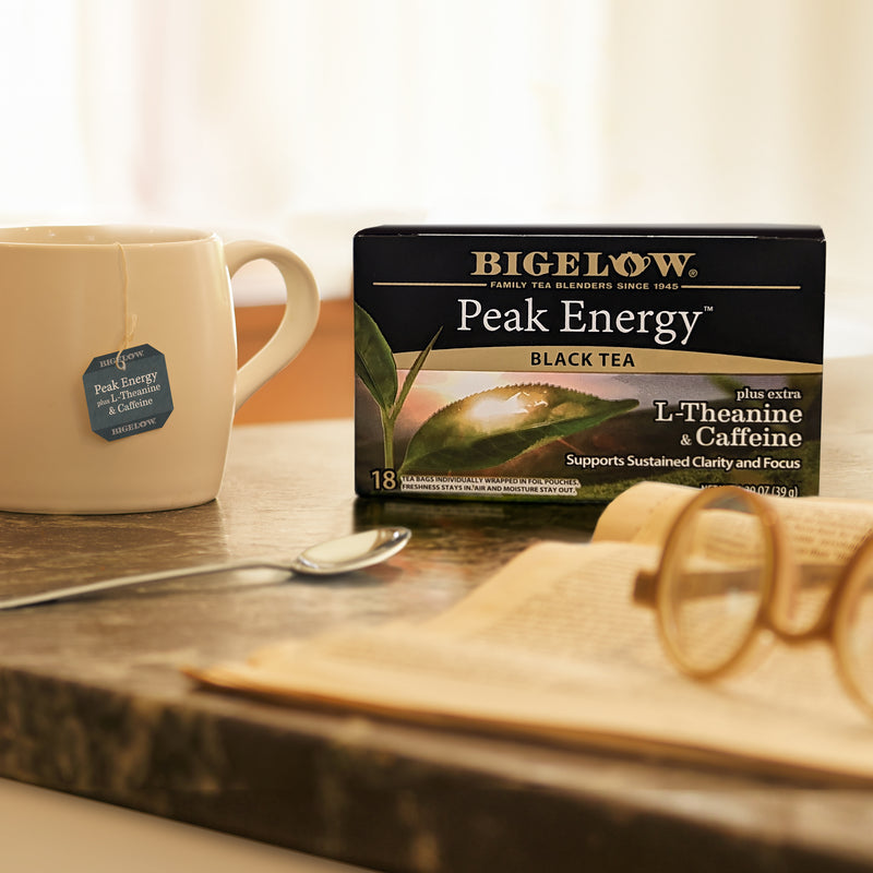 Box of Peak Energy Plus Extra L-Theanine and Caffeine Black Tea with cup of tea and foil